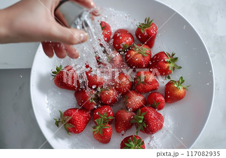 Hand washing strawberries in bowl Hand washing strawberries in bowl 117082935