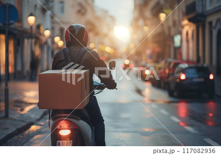 Courier on scooter with large box 117082936