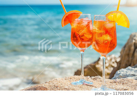 Two aperol spritz cocktails by the sea 117083056