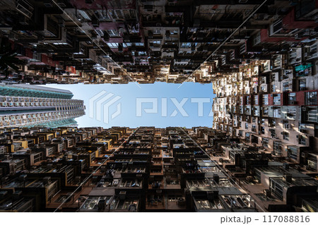 Yick Fat Building, Quarry Bay, Hong Kong. Residential area in old apartment with windows. High-rise building, skyscraper with windows of architecture in urban city. Yick Fat Building, Quarry Bay, Hong Kong. Residential area in old apartment with windows. High-rise building, skyscraper with windows of architecture in urban city. 117088816