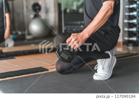 スポーツジムで握力測定器で握力を測る男性 117090184