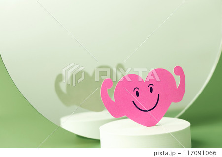 a Strong Smiling Pink Heart Paper against Mirror, represent a Very Well Mental and Body,  also Love and Organ Heart Health 117091066