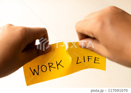 Work Life Balance Copceptual Photo, Hand Tearing Paper with Work and Life Text, Tear it Completely apart Work Life Balance Copceptual Photo, Hand Tearing Paper with Work and Life Text, Tear it Completely apart 117091070