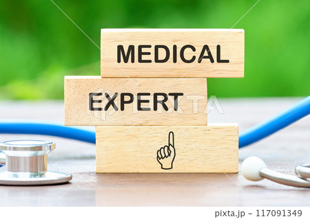 Medical concept. MEDICAL EXPERT words written on wooden blocks against a background of blurred green plants Medical concept. MEDICAL EXPERT words written on wooden blocks against a background of blurred green plants 117091349