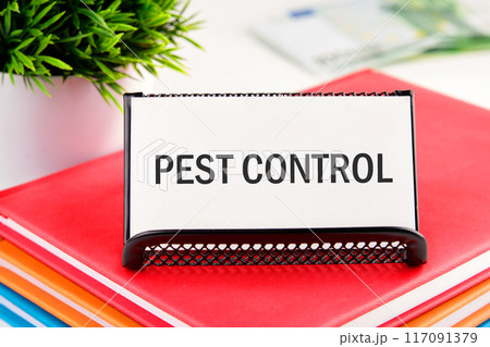 Conceptual caption Pest Control. Word PEST CONTROL Written on a business card standing in a stand on a notepad 117091379
