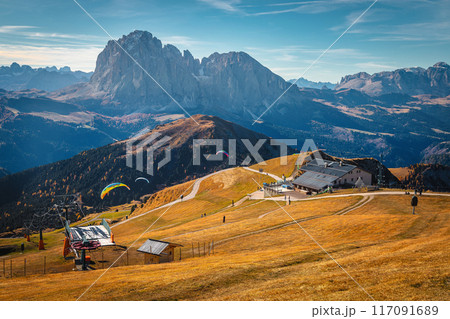 Beautiful view and paragliders flying from the Seceda, Italy Beautiful view and paragliders flying from the Seceda, Italy 117091689