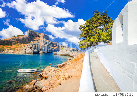 Lindos, Rhodes. Ancient acropolis and St Paul bay at Aegean Sea - Greek Islands in Greece. 117095510