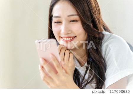 笑顔でスマホを見る女性 117098689