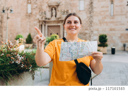 Young beautiful 30s woman holding a city map at street, old town. Attractive young female tourist is exploring new city. Traveling Europe, High quality photo Young beautiful 30s woman holding a city map at street, old town. Attractive young female tourist is exploring new city. Traveling Europe, High quality photo 117101583