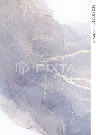 A close-up shot of a lavender and white ink swirl, showcasing the intricate patterns and textures created by the fluid movement of the inks 117102833
