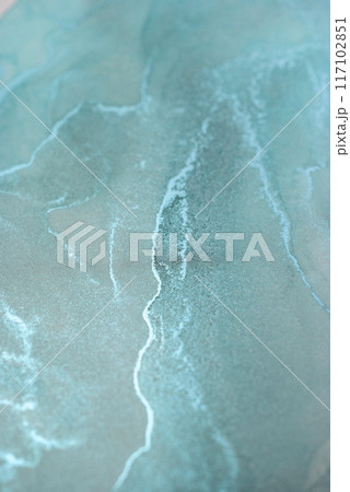 A close-up photograph of abstract teal and white swirls created through a liquid art process, capturing the beauty of flowing lines and vibrant color A close-up photograph of abstract teal and white swirls created through a liquid art process, capturing the beauty of flowing lines and vibrant color 117102851