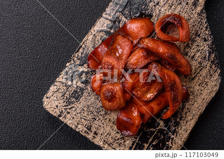 Fried sausages sliced with salt and spices as an ingredient for an English breakfast Fried sausages sliced with salt and spices as an ingredient for an English breakfast 117103049