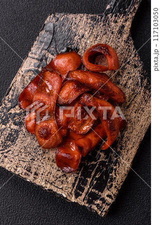 Fried sausages sliced with salt and spices as an ingredient for an English breakfast Fried sausages sliced with salt and spices as an ingredient for an English breakfast 117103050