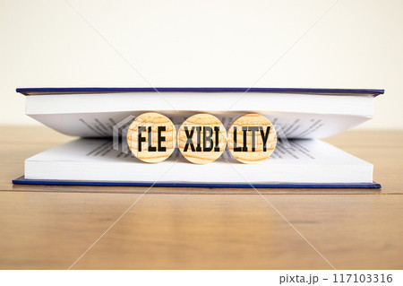 Flexibility symbol. Concept word Flexibility on beautiful wooden circles in book. Beautiful wooden table white background. Business flexibility concept. Copy space. Flexibility symbol. Concept word Flexibility on beautiful wooden circles in book. Beautiful wooden table white background. Business flexibility concept. Copy space. 117103316