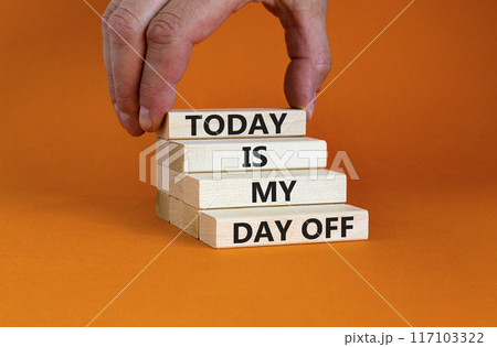 Today is my day off symbol. Concept words Today is my day off on wooden blocks. Businessman hand. Beautiful orange table orange background. Today is my day off business concept. Copy space. Today is my day off symbol. Concept words Today is my day off on wooden blocks. Businessman hand. Beautiful orange table orange background. Today is my day off business concept. Copy space. 117103322