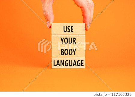 Use your body language symbol. Concept words Use your body language on wooden block. Beautiful orange table orange background. Motivational business use your body language concept. Copy space. 117103323