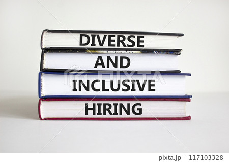 Diverse and inclusive hiring symbol. Books with words Diverse and inclusive hiring on beautiful white background. Businessman hand. Business, HR, diverse inclusive hiring concept. Copy space. Diverse and inclusive hiring symbol. Books with words Diverse and inclusive hiring on beautiful white background. Businessman hand. Business, HR, diverse inclusive hiring concept. Copy space. 117103328