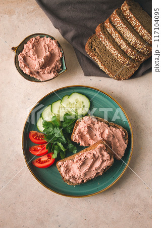 Liver meat pate spread on rye bread, breakfast, close-up, beige background. no people, selective focus, Liver meat pate spread on rye bread, breakfast, close-up, beige background. no people, selective focus, 117104095