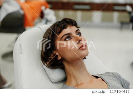 Young Woman Receiving Beauty Treatment in Modern Salon During Daylight Hours Young Woman Receiving Beauty Treatment in Modern Salon During Daylight Hours 117104412