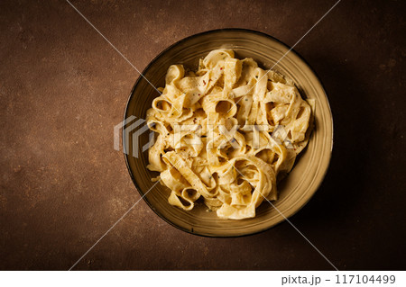 Fettuccine, tagliatelle, in creamy garlic sauce, Italian traditional cuisine, pasta carbonaro, Fettuccine, tagliatelle, in creamy garlic sauce, Italian traditional cuisine, pasta carbonaro, 117104499