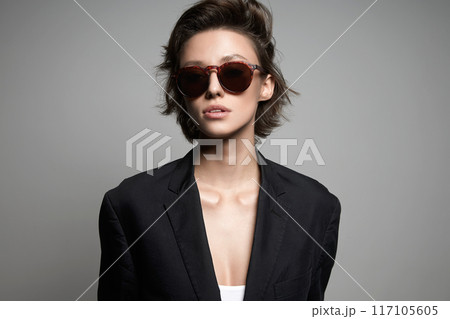 Beautiful woman with short hair in sunglasses. beauty sexy girl in oversize suit 117105605