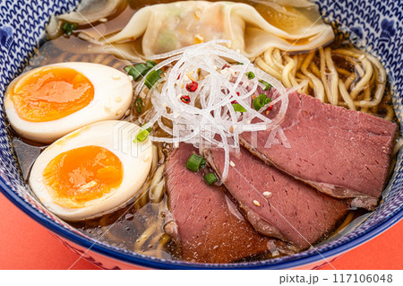 Portion of japanese ramen with pastrami and egg 117106048