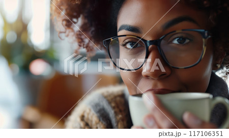 Close-up of a focused individual with glasses participating in a virtual training session 117106351