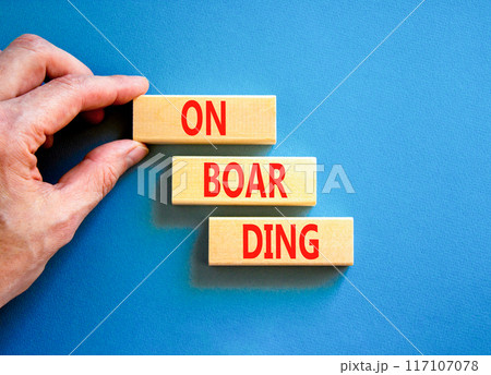 Onboarding success symbol. Concept word Onboarding on wooden blocks. Businessman hand. Beautiful blue background. Business onboarding success concept. Copy space. Onboarding success symbol. Concept word Onboarding on wooden blocks. Businessman hand. Beautiful blue background. Business onboarding success concept. Copy space. 117107078