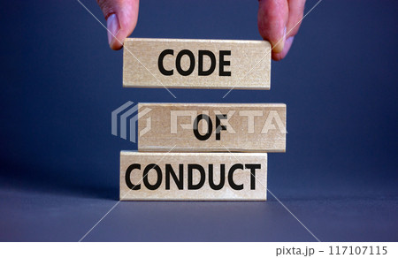 Code of conduct symbol. Concept words 'Code of conduct' on wooden blocks on a beautiful grey background. Businessman hand. Business and code of conduct concept. Copy space. 117107115