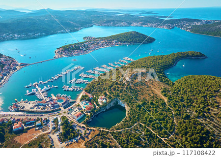 Aerial view of sea landscape with coastal town and yachts. Touristic city for summer vacation among Islands in Adriatic sea. Panoramic view of marina Frapa and Dragon Eye lake in Rogoznica, Croatia 117108422