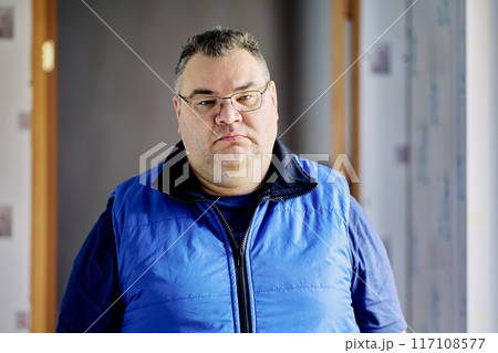 Gloomy large built European man of about 40 wearing glasses. Gloomy large built European man of about 40 wearing glasses. 117108577