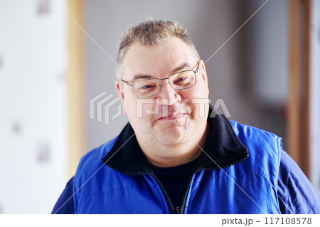 Fat man tries to hold back smile on his cheeky face. Fat man tries to hold back smile on his cheeky face. 117108578