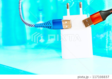 Charger,two red blue usb cables on bright grunge azure surface 117108837