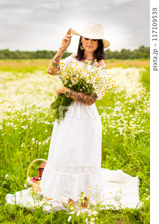 Beautiful young girl with curly red hair in camomile field Beautiful young girl with curly red hair in camomile field 117109539