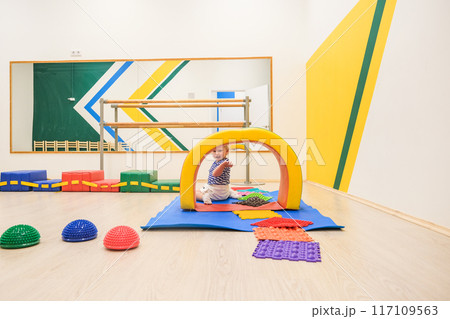 Beautiful blonde baby girl playing in kindergarten 117109563