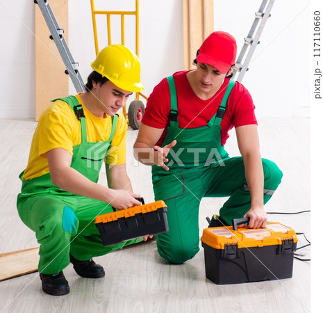 Two workers contractors working indoors Two workers contractors working indoors 117110660