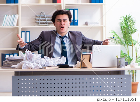 Businessman rejecting new ideas with lots of papers 117111051