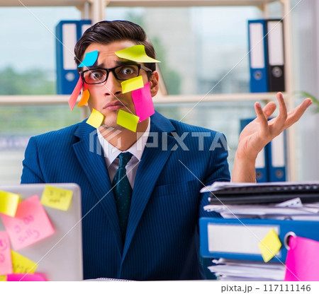 Businessman with reminder notes in multitasking concept Businessman with reminder notes in multitasking concept 117111146