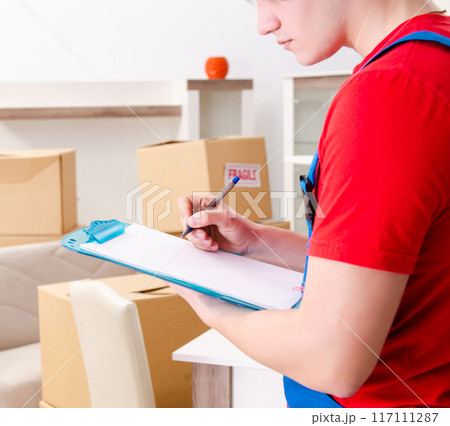 Young male contractor with boxes working indoors Young male contractor with boxes working indoors 117111287