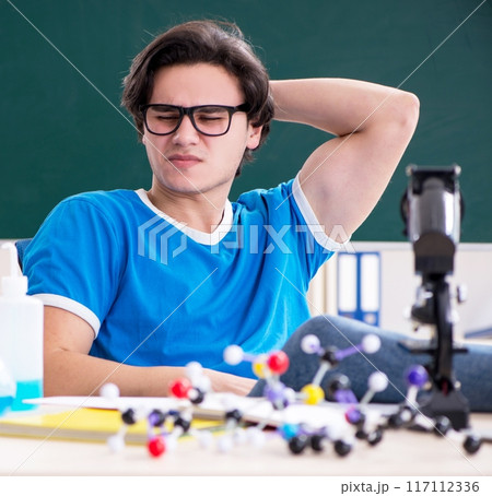 Young male student in the classroom 117112336
