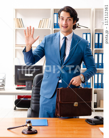Young handsome judge sitting in courtroom Young handsome judge sitting in courtroom 117112361