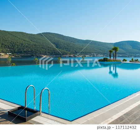 Nice swimming pool outdoors on bright summer day 117112432
