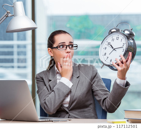 Businesswoman failing to meet her deadlines in business concept Businesswoman failing to meet her deadlines in business concept 117112501