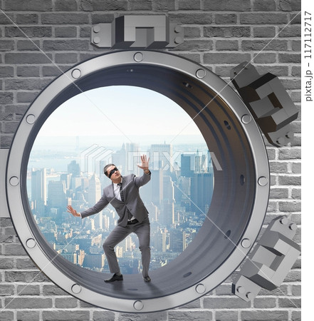 Blindfolded businessman in front ot vault door 117112717