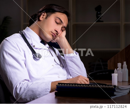 Young male doctor in the hospital at night Young male doctor in the hospital at night 117112824