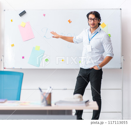 Young handsome male designer working in the office Young handsome male designer working in the office 117113055