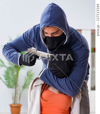 Armed man assaulting young woman at home 117113184