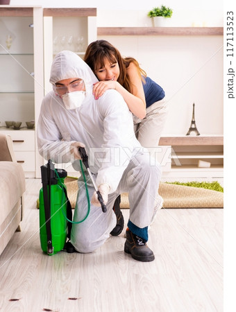 Young professional contractor doing pest control at flat 117113523