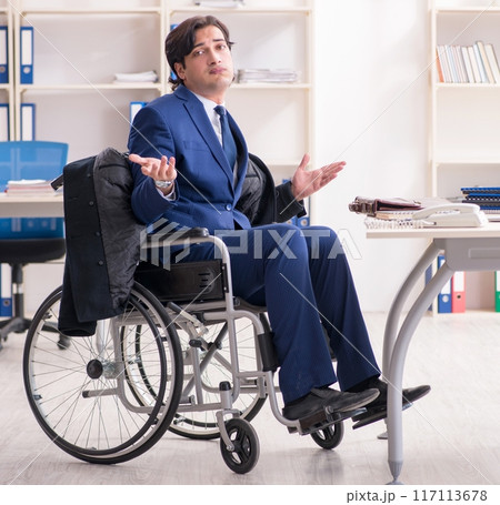 Young male employee in wheelchair working in the office Young male employee in wheelchair working in the office 117113678