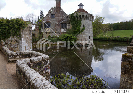 Scotney Castle in Kent England with moat and surrounded by farmland 117114328